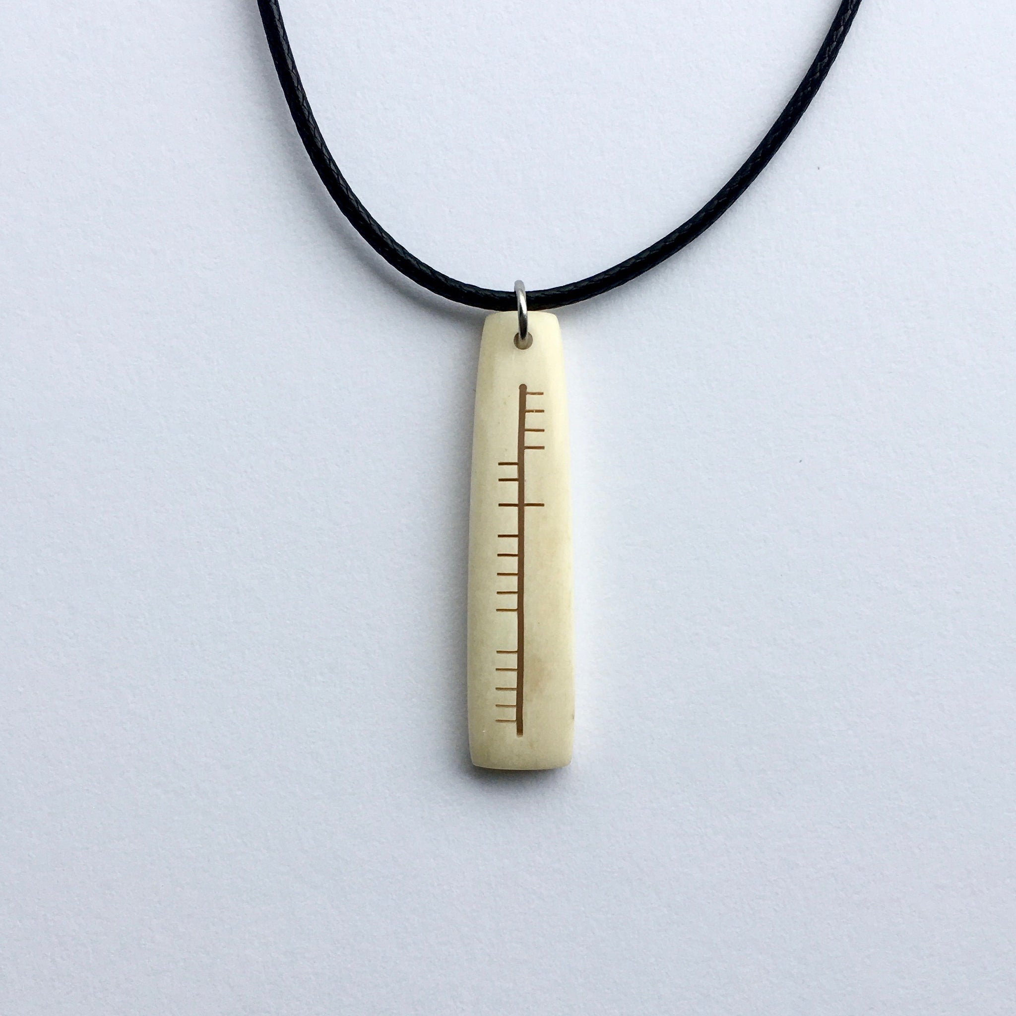 Ogham carved pendant